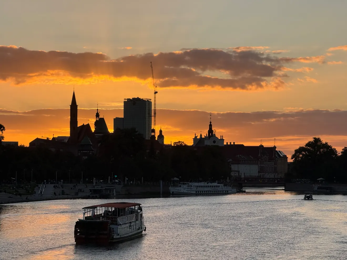 Riverside silhouettes of Wrocław, Poland, at sunset